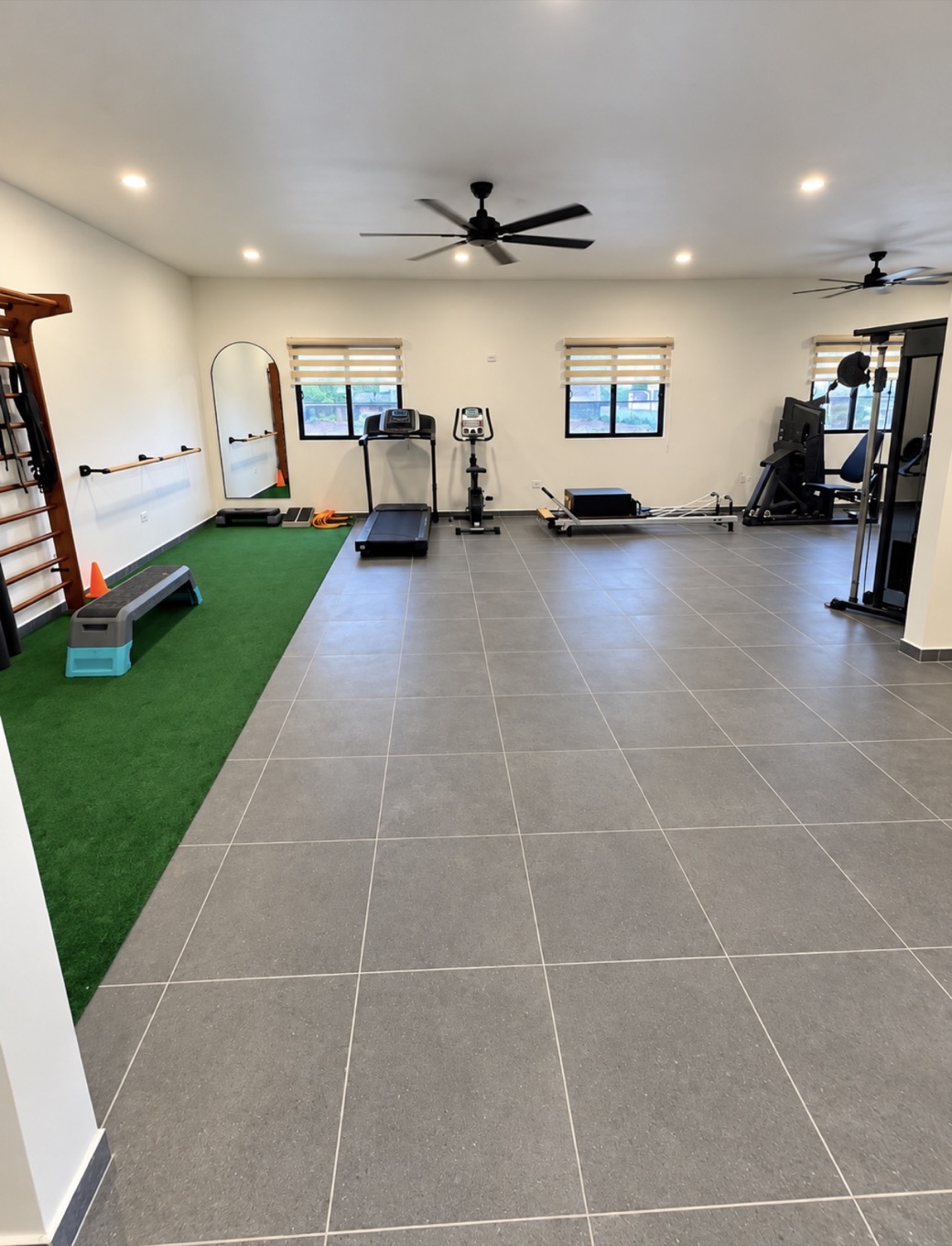 Exercise area with treadmill, stationary bike and Pilates reformer